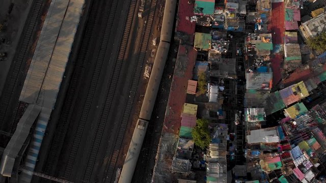 Indian train passing under a busy road bridge near Dhobi Ghat Mumbai