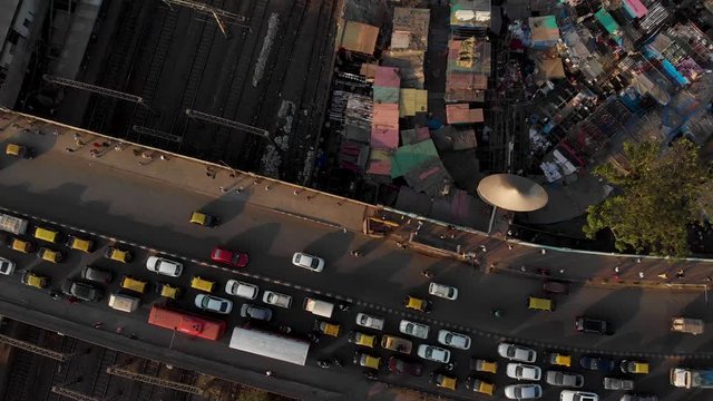Drone shot over Mumbai local train tracks, Dhobi Ghat and a busy road bridge