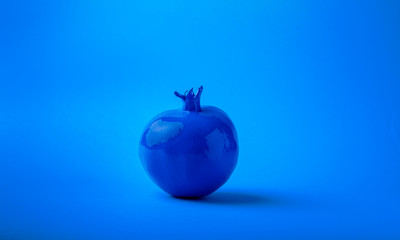 blue painted grenade on a blue background