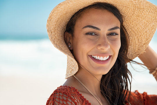 Beautiful girl with straw hat at beach