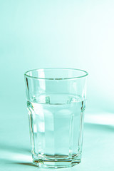 Pure clear water in a glass and jug stands on a white background