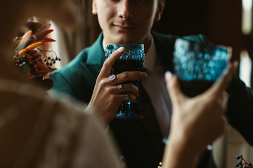couple drinks red wine from beautiful glasses in a restaurant in Lviv