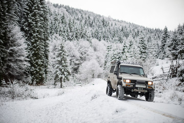 Fototapeta na wymiar Off road car in snowy forest