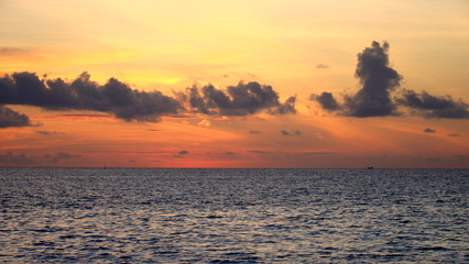 A beautiful and romantic sunset at the Maldives seen from a luxurious villa. Holidaying in Maldives without seeing a sunset is a bit like going to Paris without seeing the Eiffel Tower.