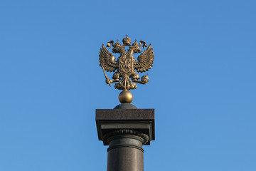 Fototapeta na wymiar double-headed eagle coat of arms of Russia on a background of blue sky