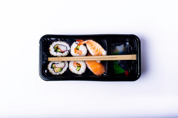sushi packaged in a reclinable container on a white background