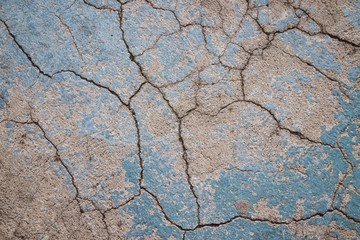 Cracked concrete, rough texture with some azure paint.