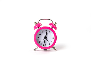 Table clock alarm clock in a classic shape. The case is metallic pink. Background for those who do not waste time in vain.