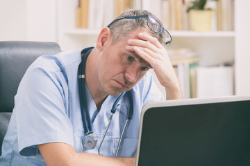 Overworked doctor in his office