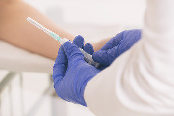 Doctor's hands holding a ready-to-use syringe