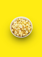 popcorn in  bowl on yellow background