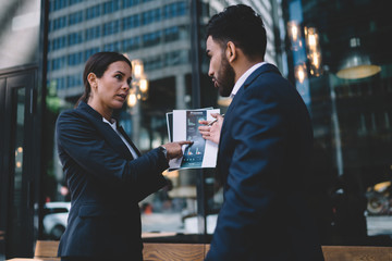 Worried multiethnic colleagues brainstorming during meeting in office