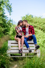 Romantic feelings. man with girl in park. couple in love. Checkered fashion. family weekend....
