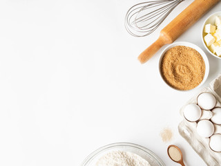 Frame of various baking ingredients - flour, eggs, sugar, butter, dry yeast, and kitchen utensils...