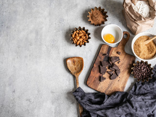 Various ingredients for making sweet pastries on a gray background.