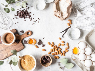 Cooking flat lay frame of various food ingredients for baking on a white background. Copy space....