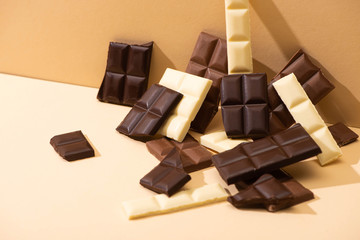sweet delicious dark, milk and white chocolate on beige background