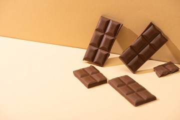 sweet delicious milk chocolate on beige background