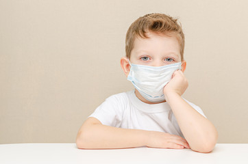 Cute boy of four years in a medical mask. Quarantined children due to an epidemic.