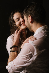 Beautiful couple under the rain at night time, romantic view, walking and kissing couple.