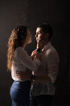 Beautiful couple under the rain at night time, romantic view, walking and kissing couple.