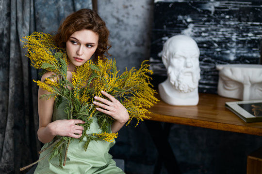 beautiful girl with spring yellow flowers