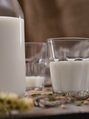 Jug and glass of milk on wooden table. Country breakfast on World Milk Day. Vertical shot.