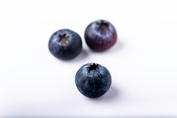 three blueberries on a white background