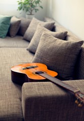 Acoustic guitar on sofa in living room
