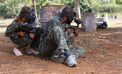 Fototapeta premium Paintball players of opposite teams in shootout