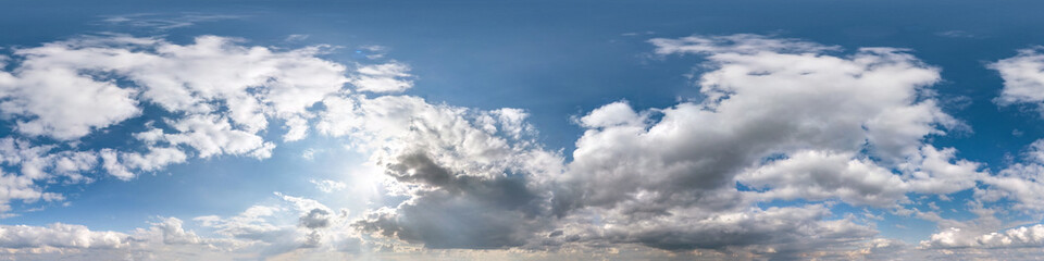 Seamless hdri panorama 360 degrees angle view blue sky with beautiful fluffy cumulus clouds with zenith for use in 3d graphics or game development as sky dome or edit drone shot