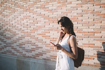 Tourist woman browsing phone on street