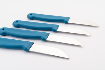 Obraz premium four sharp knives with blue plastic handle on white background