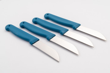 four sharp knives with blue plastic handle on white background