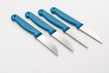 four sharp knives with blue plastic handle on white background