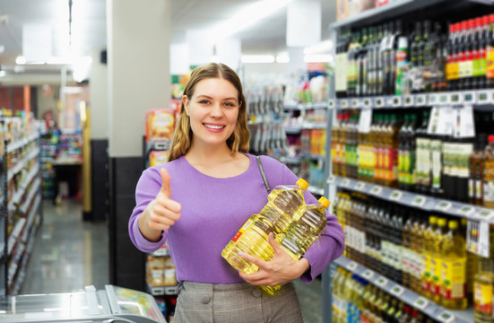 female want to buying bottle of oil