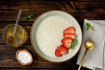 Top view of taioca pudding with plant-based milk on dark rustic background