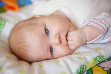 newborn baby licks her fingers