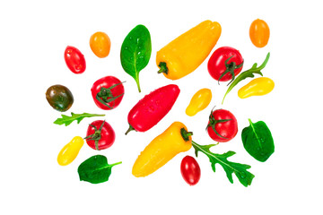 Top view of various fresh vegetables and herbs with drops of water isolated on white