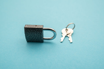 Metal lock isolated on blue background.