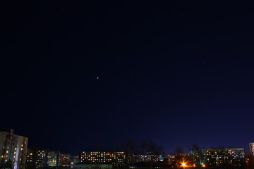 Fototapeta premium Venus among the stars in the night sky over the city