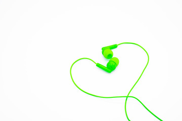 Green EarPods Basic In-Ear Headphone Earbuds heart shaped. Copy space