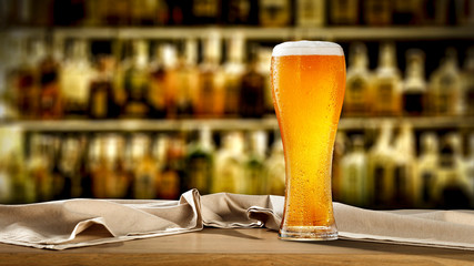 Cold beer on desk and free space for your decoration.Blurred bar and copy space for your...