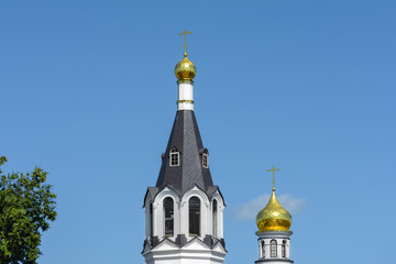 Fototapeta na wymiar Polesskaya Church or Church of St. Nicholas the Wonderworker in Gomel. St. Nicholas Monastery. Domes and bell tower of the monastery and churches.