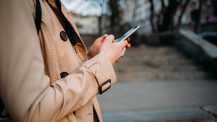 Young woman wearing beige coat
