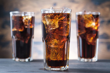 Fototapeta Three cola glass with ice cubes and bubbles. Cold sweet drink obraz