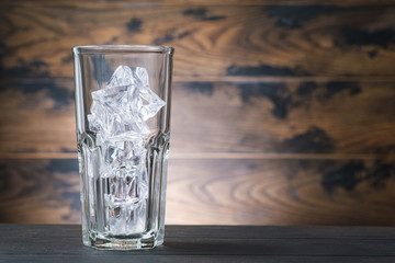 Empty cola glass with ice cubes