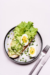 Open sandwich with cream cheese, cucumber, lettuce and egg. Morning and Breakfast. Healthy nutrition. Selective focus