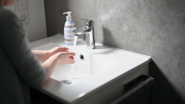 Corona virus prevention child showing hand hygiene washing hands with soap