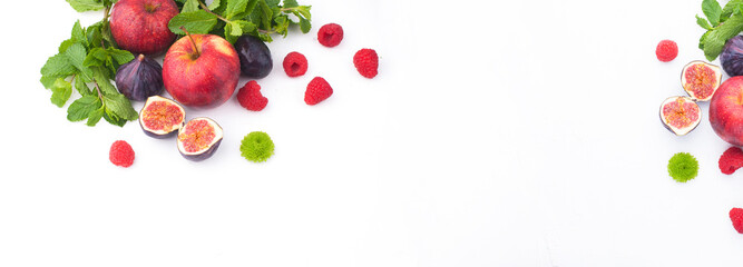 Different berries and fruits. Assortment of fruit harvest on a white background. Figs, apples, raspberries, mint. Free space for text. Banner, long format. Copy space